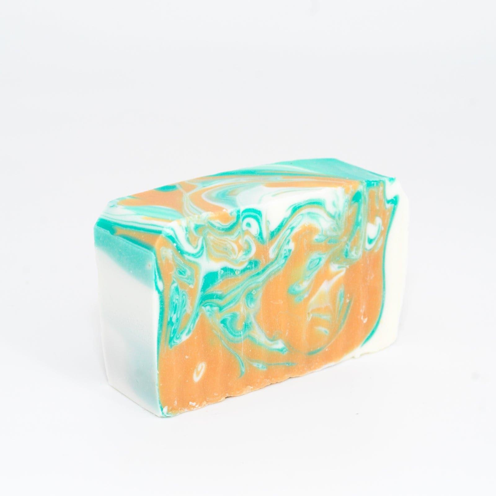 angled right view of a teal, orange, and white Narcissist Soap Bar