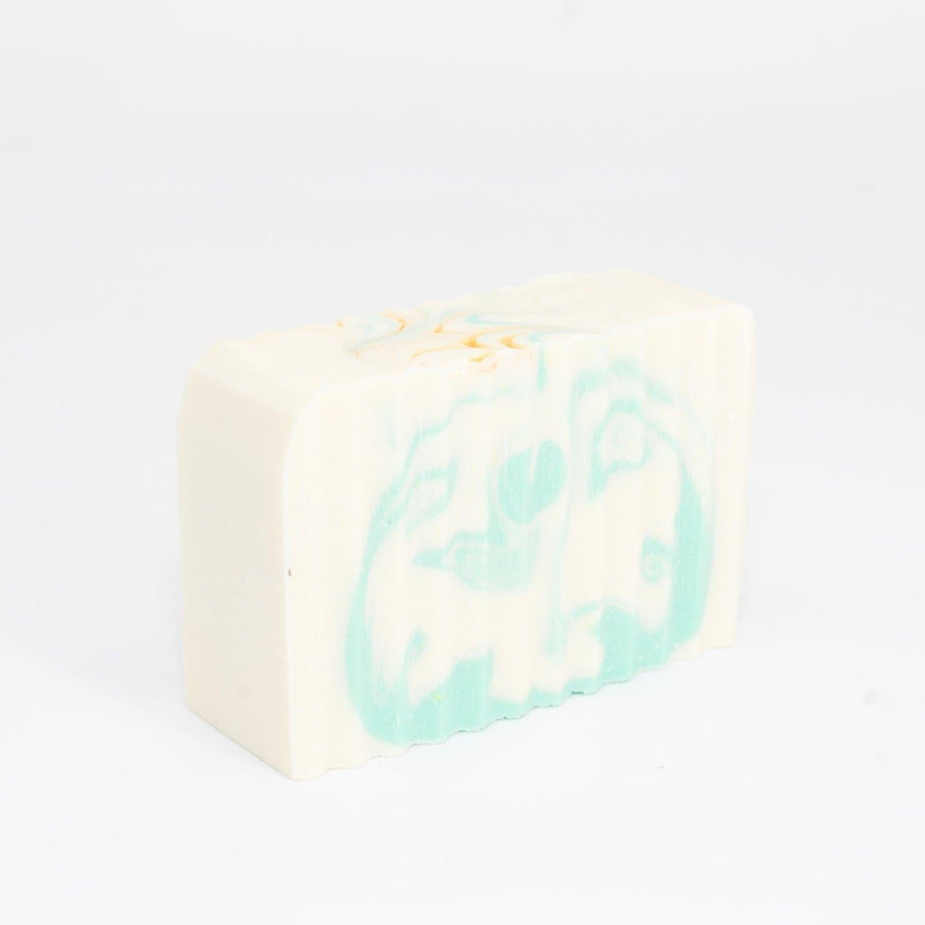 Narcissist Soap Bar with blue and bronze swirls on side against white background