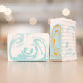 one Narcissist Shea Butter Soap Bar placed horizontally and another placed vertically next to it