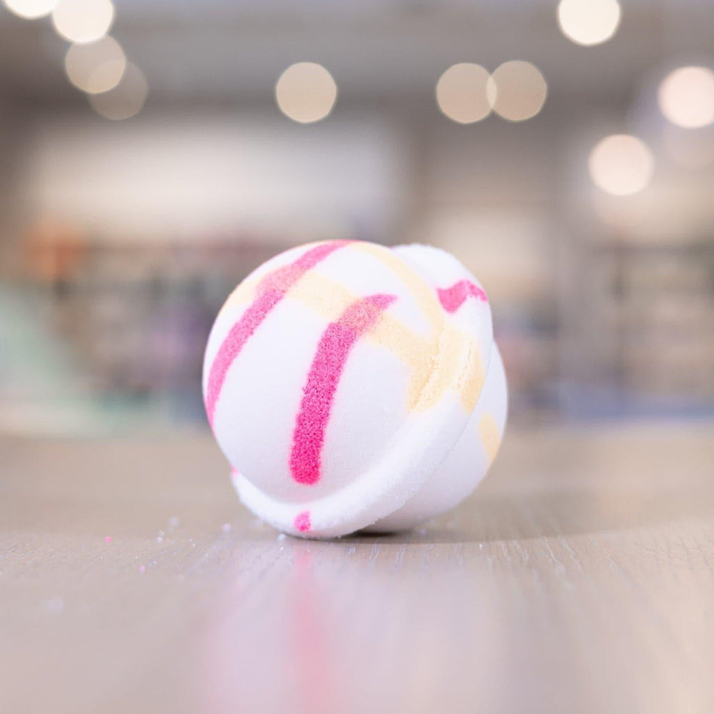 White bath bomb with light yellow and hot pink design