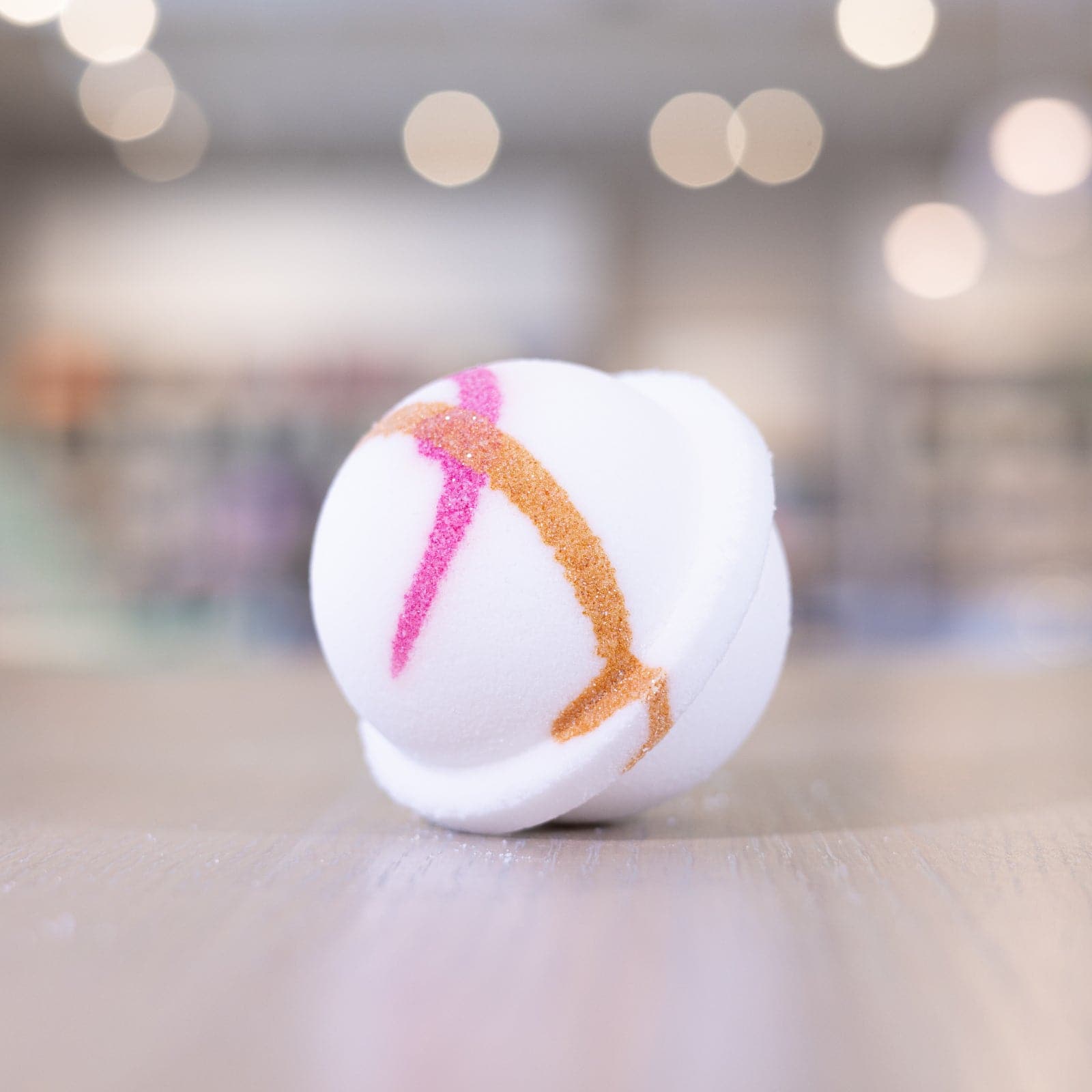 Pink orange design on white circle bath bomb